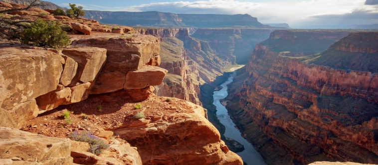 Which state boasts the Grand Canyon, that massive scar of beauty carved by the Colorado River?